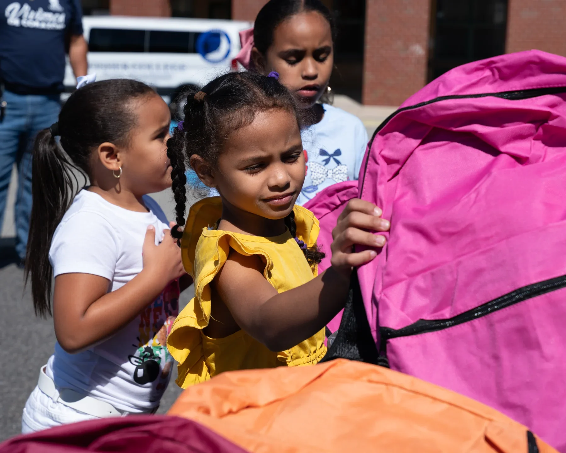 A child holding donated classroom supplies